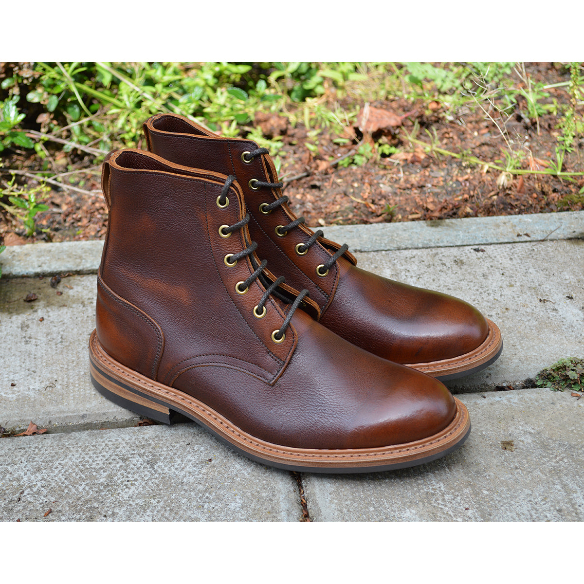 A brown leather service boot with a dainite sole and brass eyelets, designed for the forestry industry.