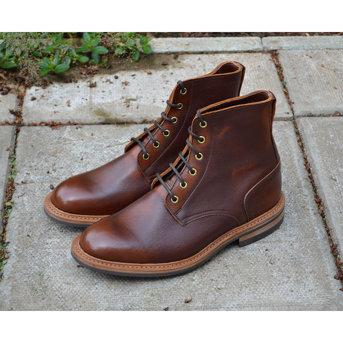 A brown leather service boot with a dainite sole and brass eyelets, designed for the forestry industry.