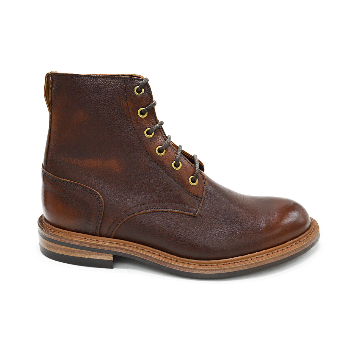 A brown leather service boot with a dainite sole and brass eyelets, designed for the forestry industry.