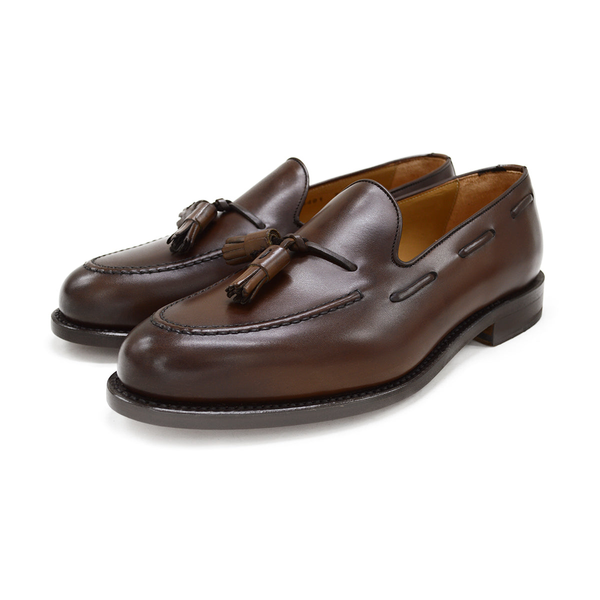 A Berwick 1707 brown tasseled loafer shoe with a closed toe and leather sole.
