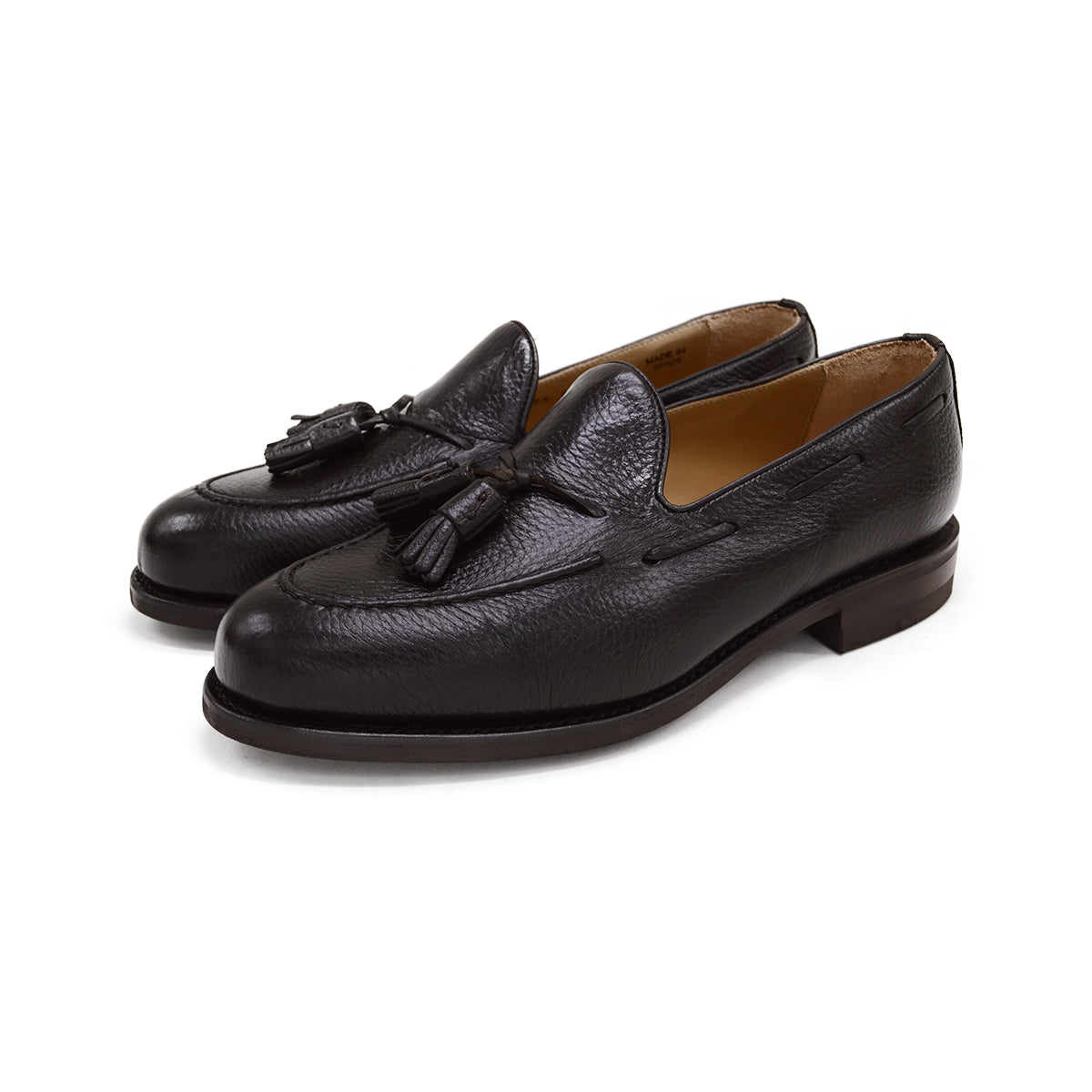 A Berwick 1707 dark brown deerskin slip-on loafer with a tassel detail on the vamp & Dainite sole, displayed on a plain background