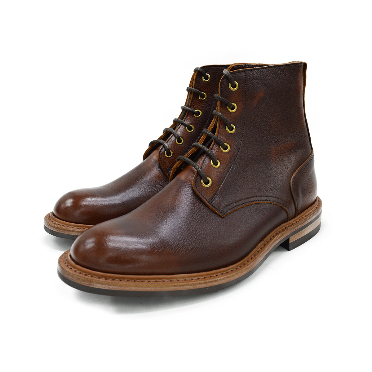 A brown leather service boot with a dainite sole and brass eyelets, designed for the forestry industry.