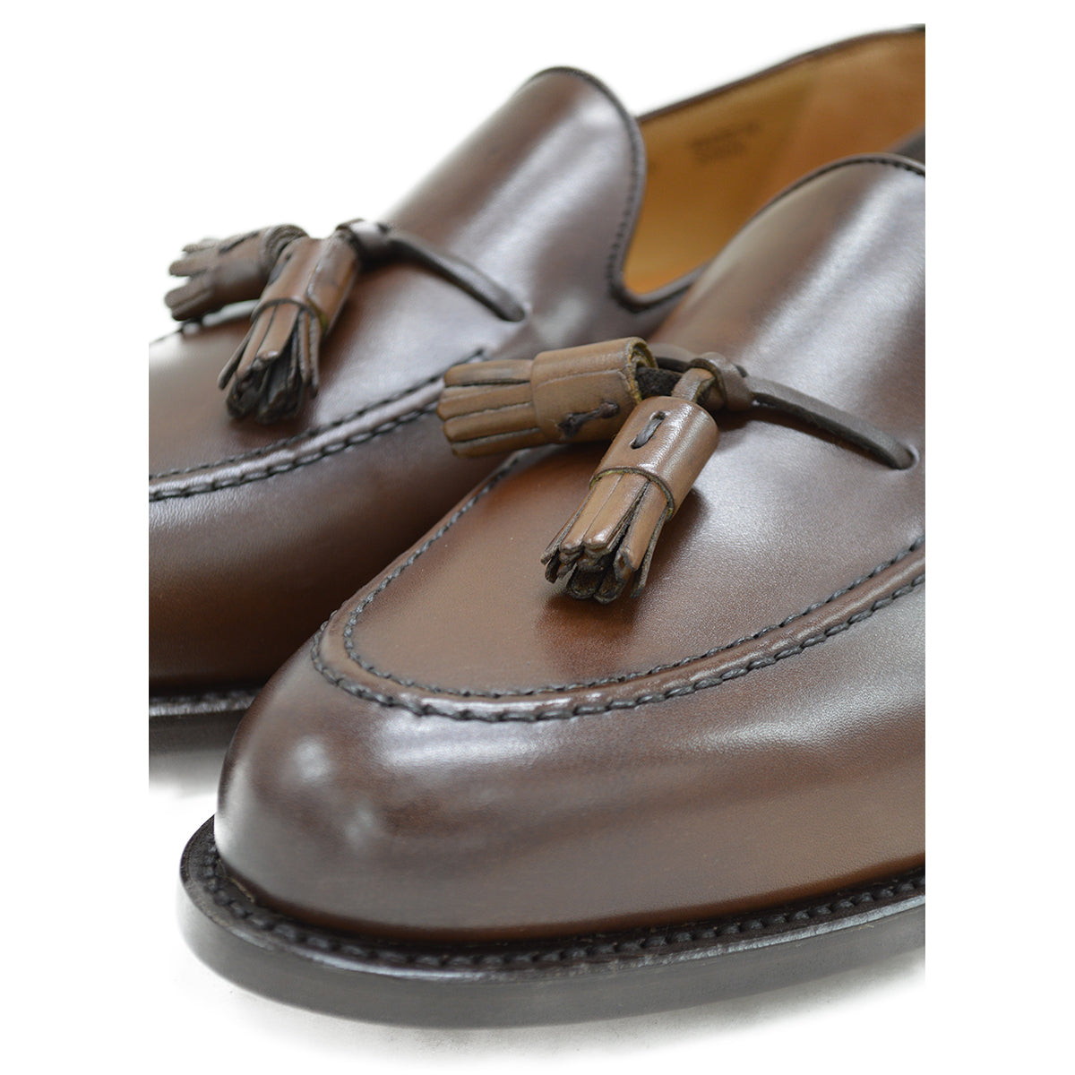 A Berwick 1707 brown tasseled loafer shoe with a closed toe and leather sole.