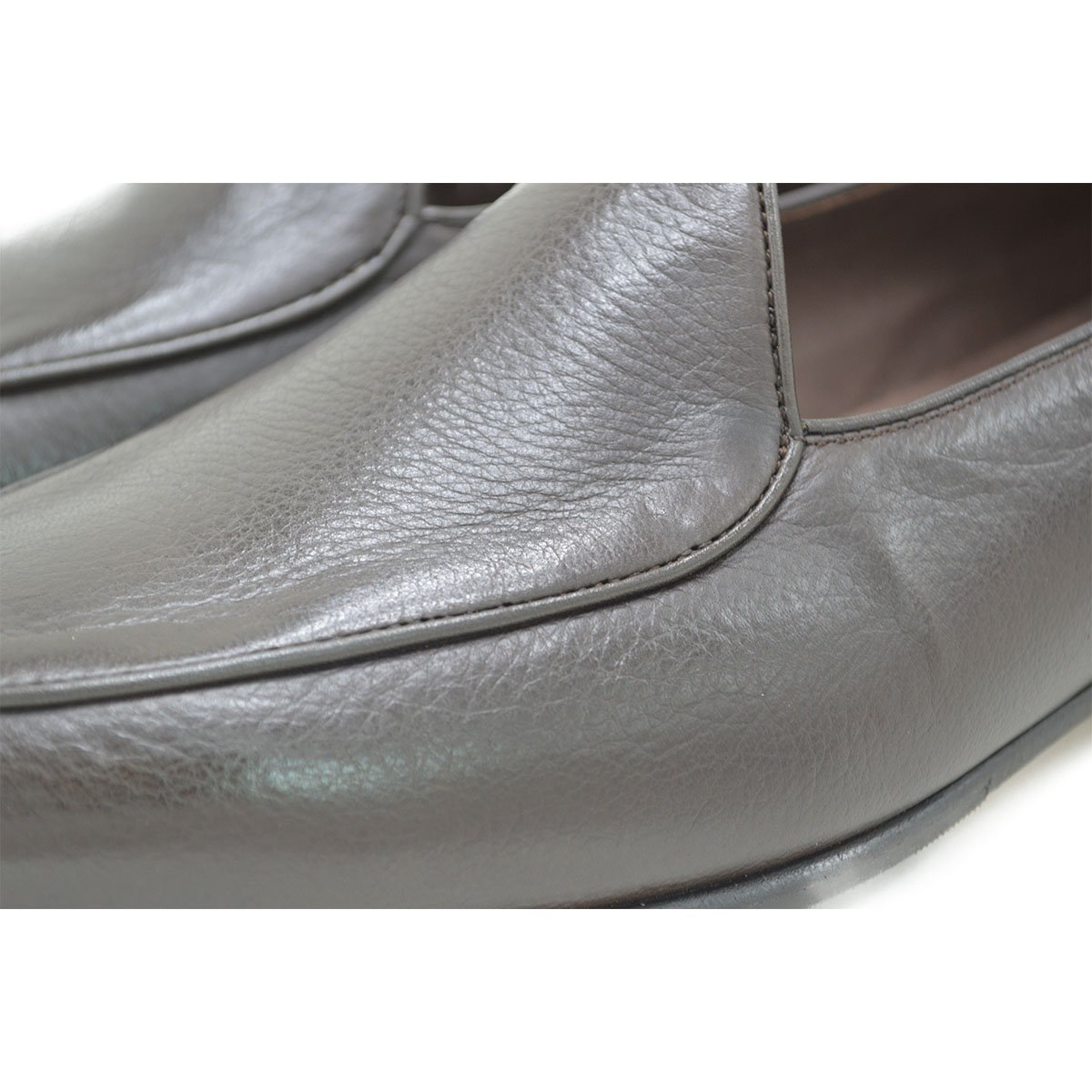 A dark brown deerskin leather Belgian loafer with an almond toe shape and minimal stitching.