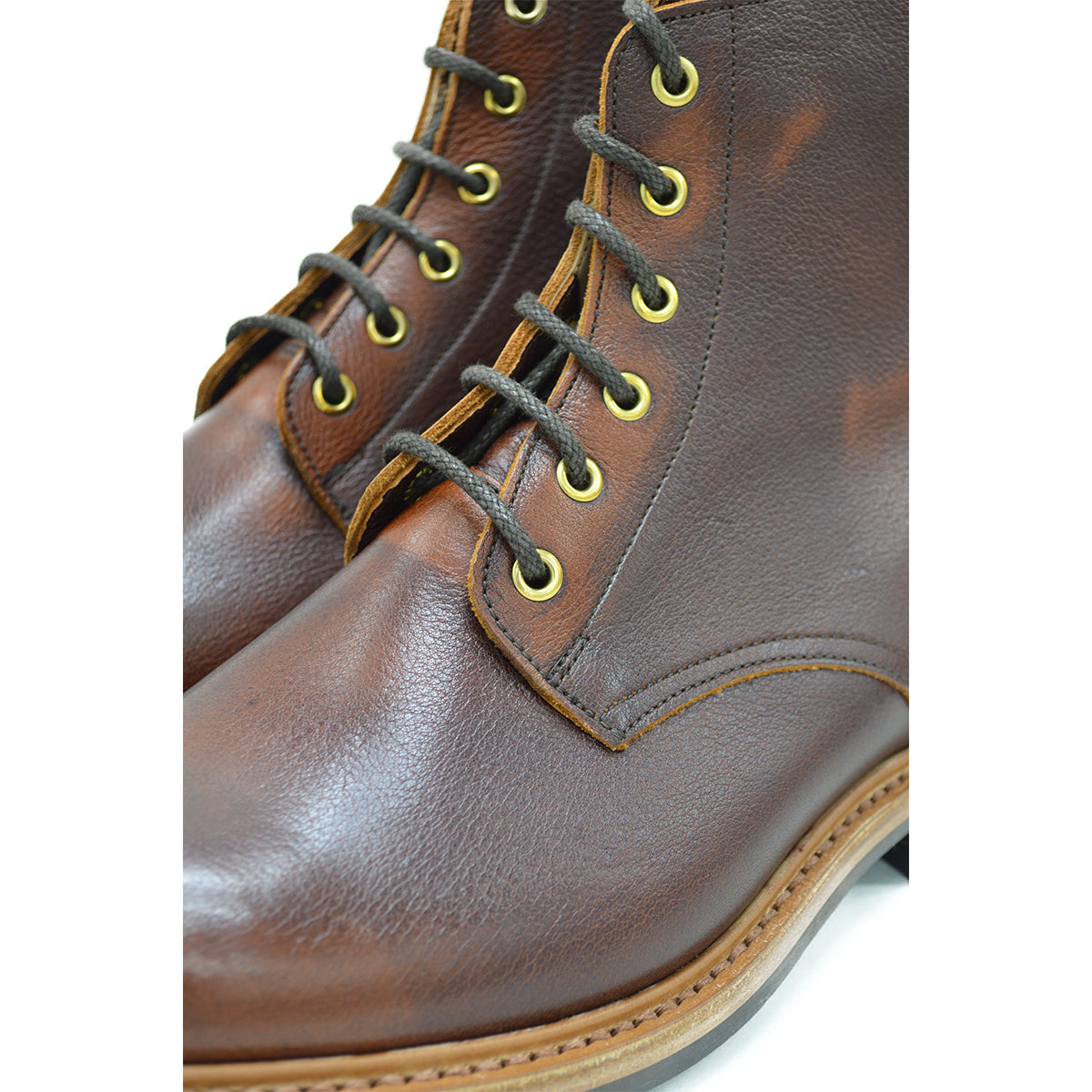 A brown leather service boot with a dainite sole and brass eyelets, designed for the forestry industry.