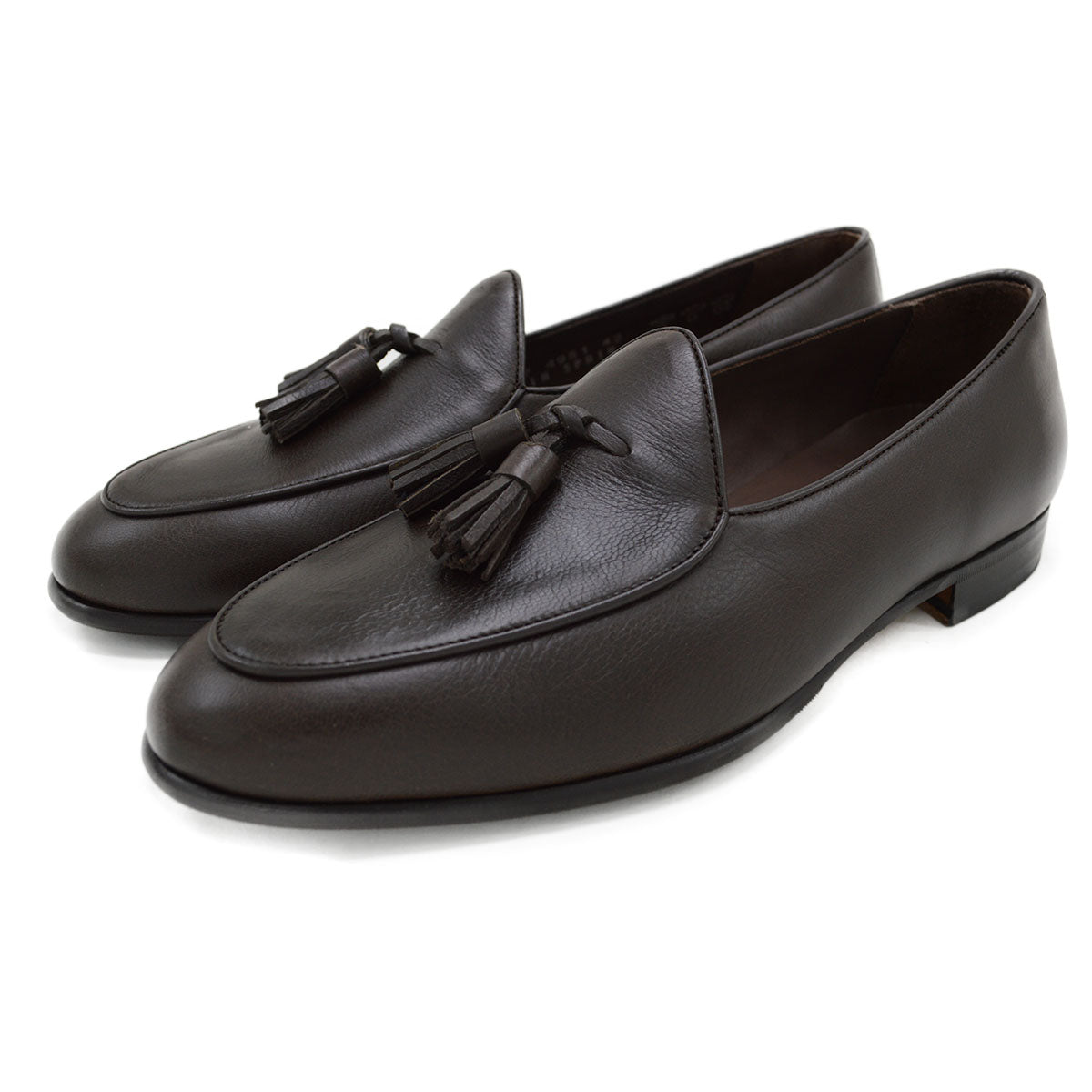 A Berwick 1707 dark brown deerskin Belgian loafer with a tassel detail on the vamp, displayed on a white background.