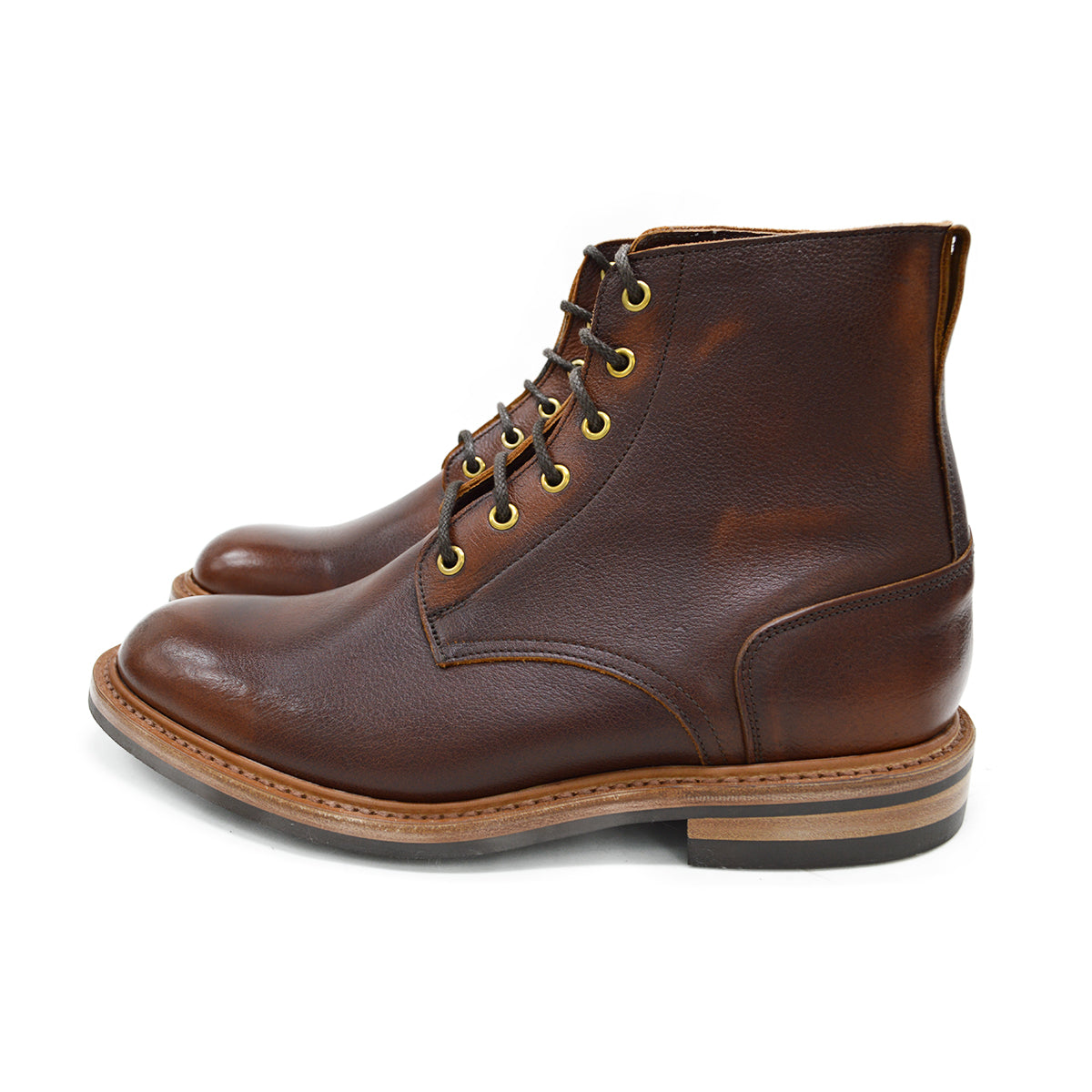 A brown leather service boot with a dainite sole and brass eyelets, designed for the forestry industry.