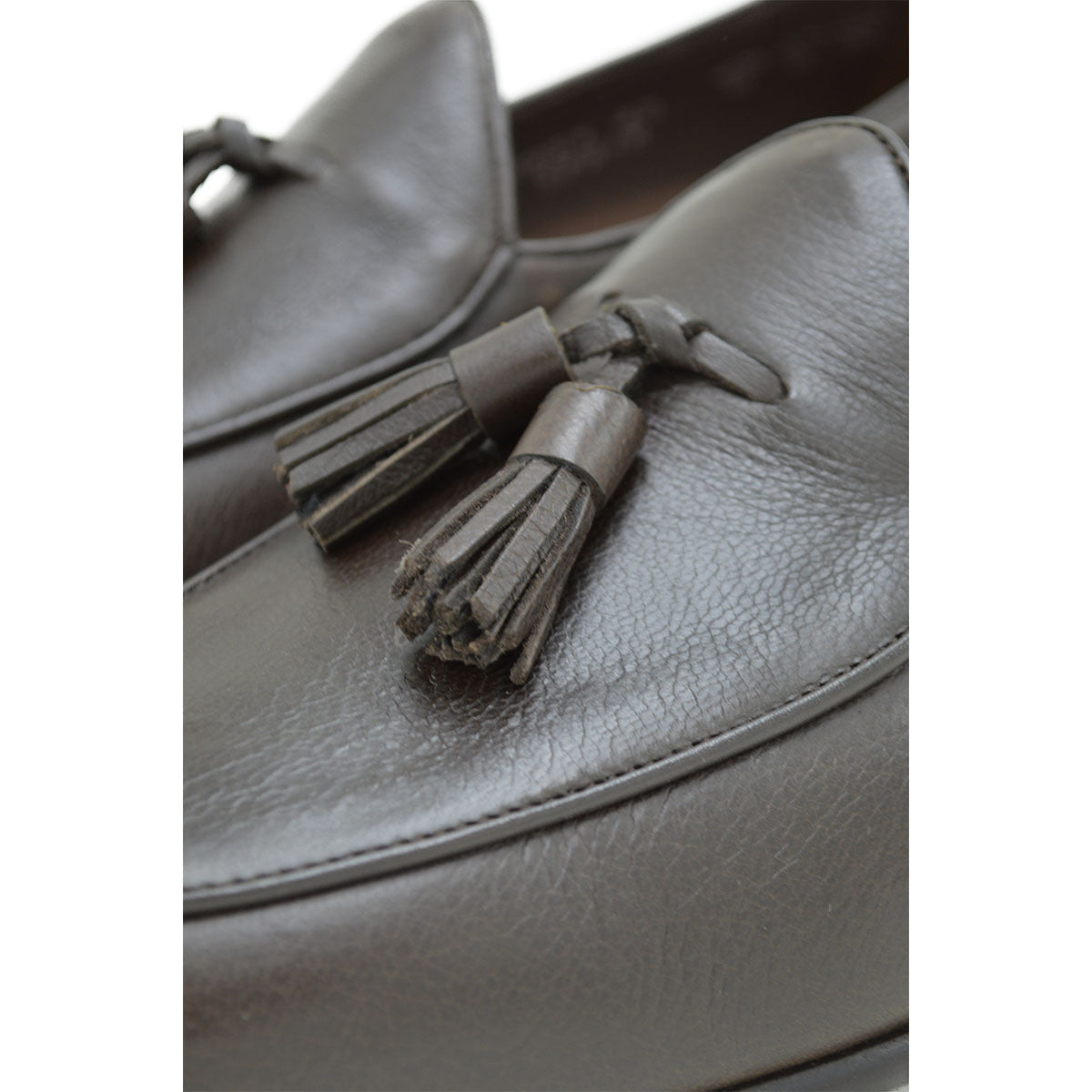 A Berwick 1707 dark brown deerskin Belgian loafer with a tassel detail on the vamp, displayed on a white background.