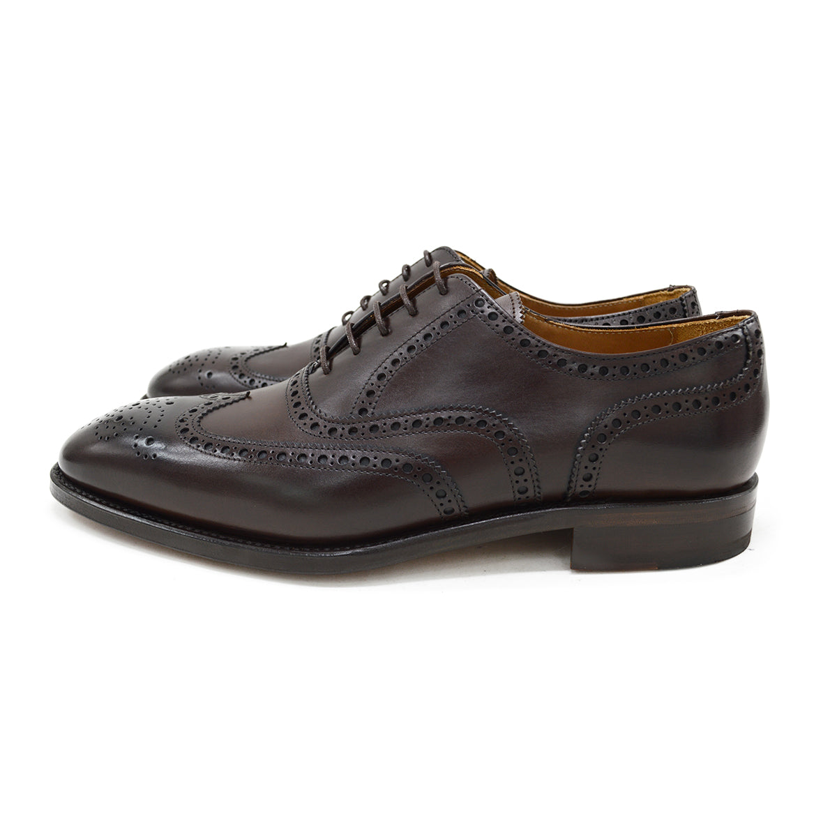 A dark brown Oxford brogue shoe with intricate brogue detailing and a goodyear welted leather sole.