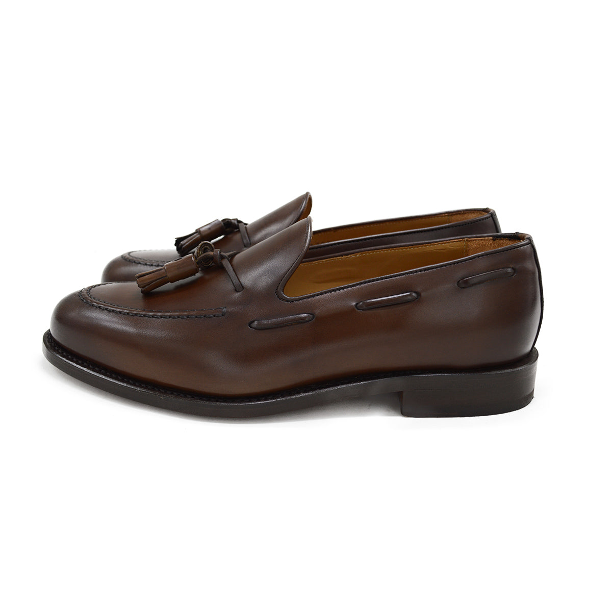 A Berwick 1707 brown tasseled loafer shoe with a closed toe and leather sole.