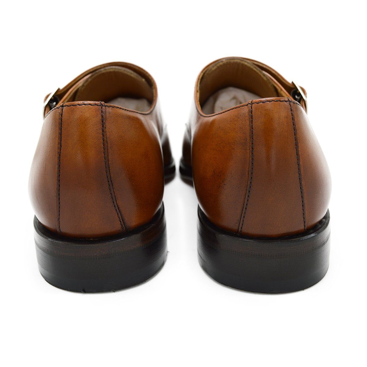 A brown double monk strap shoe with a polished leather upper and a Goodyear welted sole.