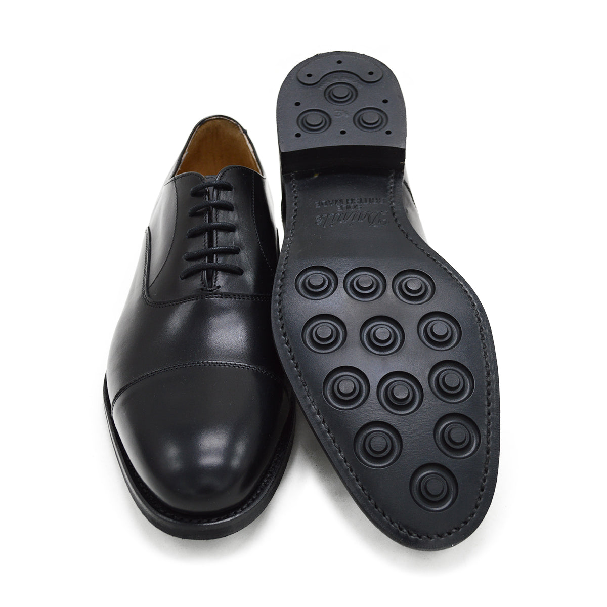 A Berwick 1707 black Oxford shoe with a polished, smooth upper and a Dainite rubber sole.