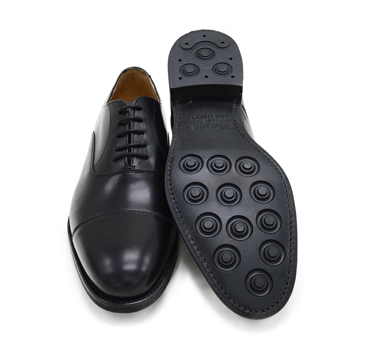 A Berwick 1707 black Oxford shoe with a polished, smooth upper and a Dainite rubber sole.