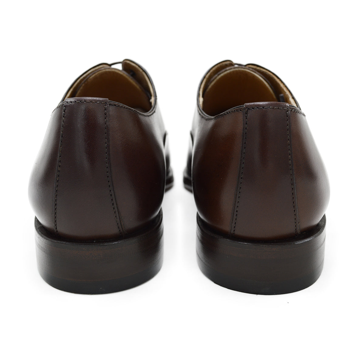 A Berwick 1707 dark brown, chisel toe Oxford shoe with a lace-up closure and a single leather sole.