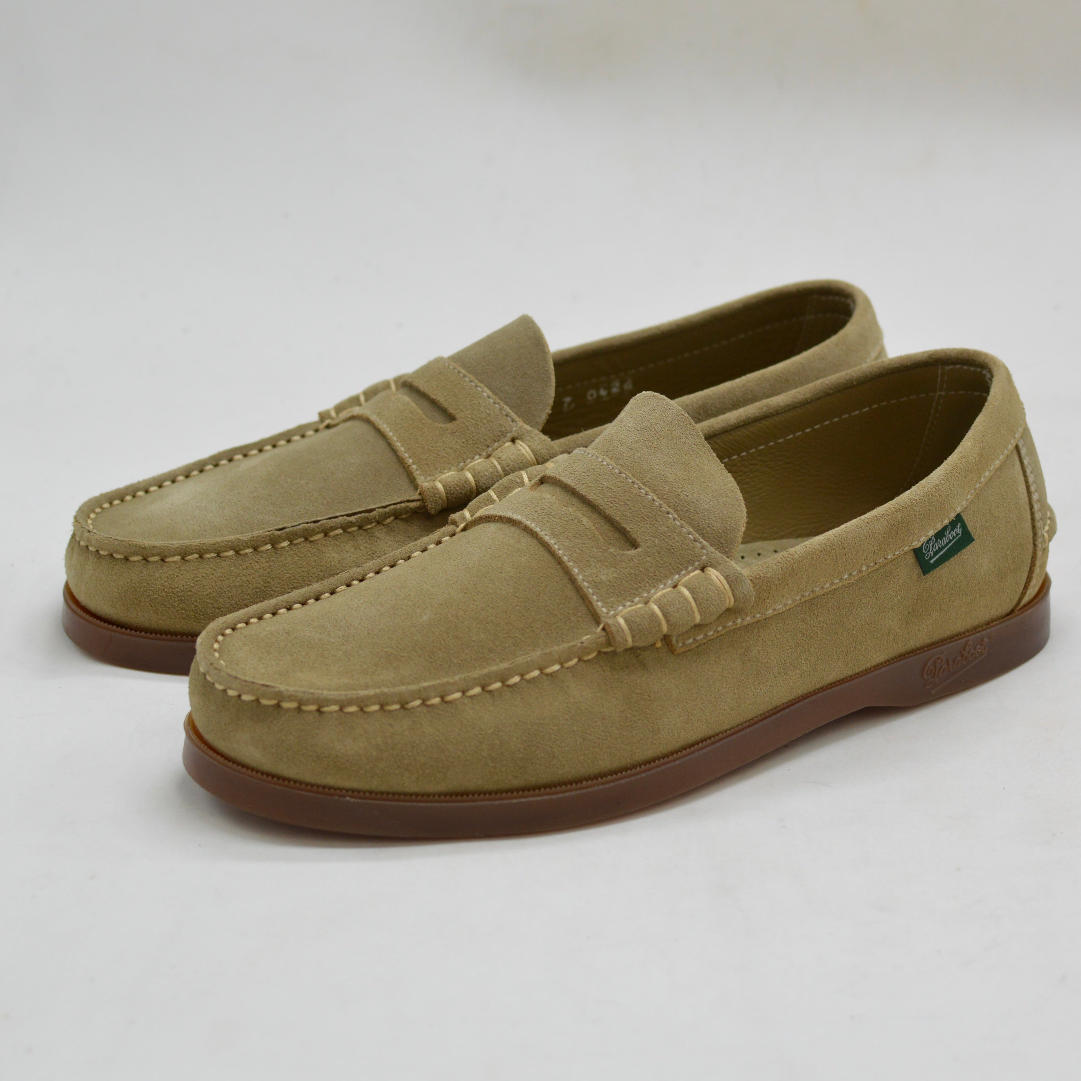 Pair of sand loafers on a white background