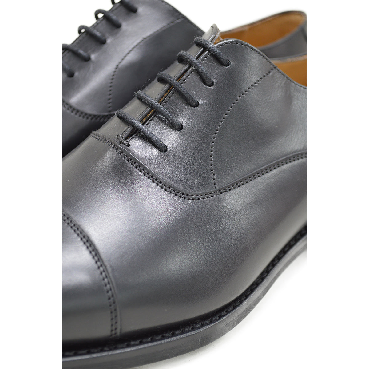 A Berwick 1707 black Oxford shoe with a polished, smooth upper and a Dainite rubber sole.