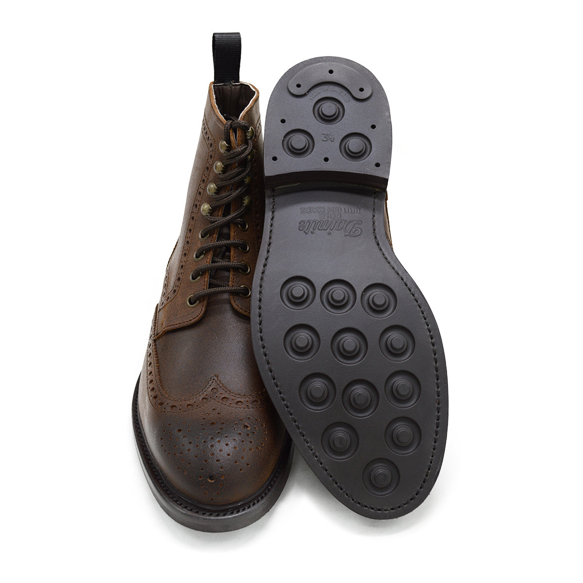 A dark brown lace-up brogue boot with a rubber sole and visible stitching on the upper part.