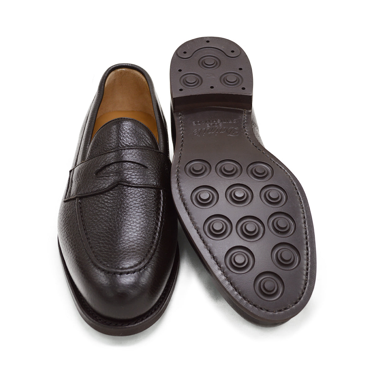 A dark brown deerskin penny loafer with a velvety soft texture and a classic round toe shape on a white background with Dainite Studded Rubber Sole.