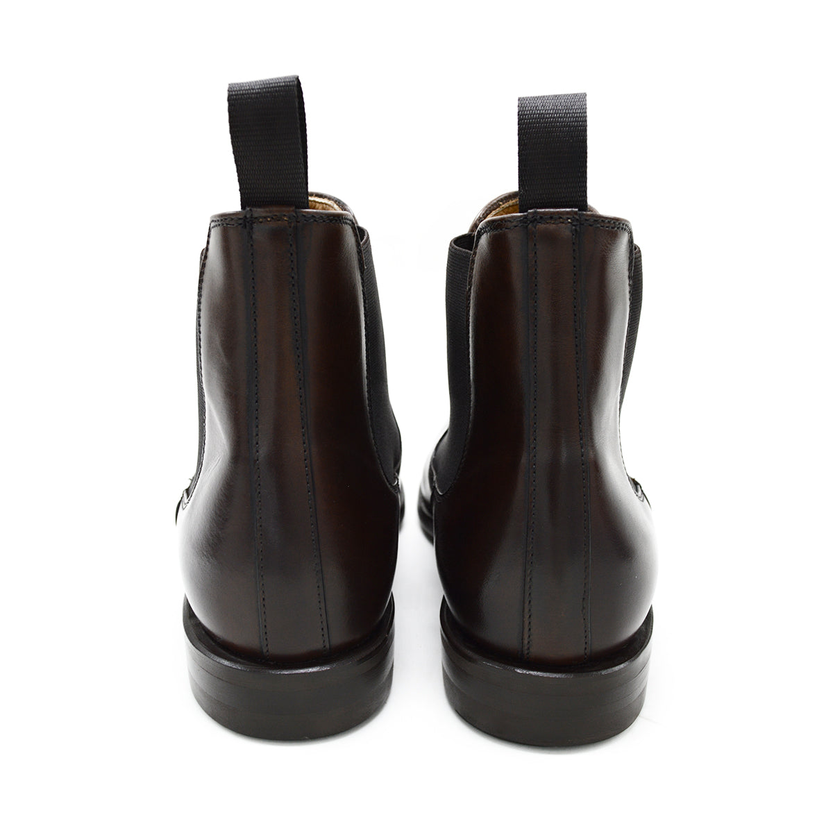 A dark brown leather Chelsea boot with a side pull tab and a low heel & Dainite soles, displayed on a white background.
