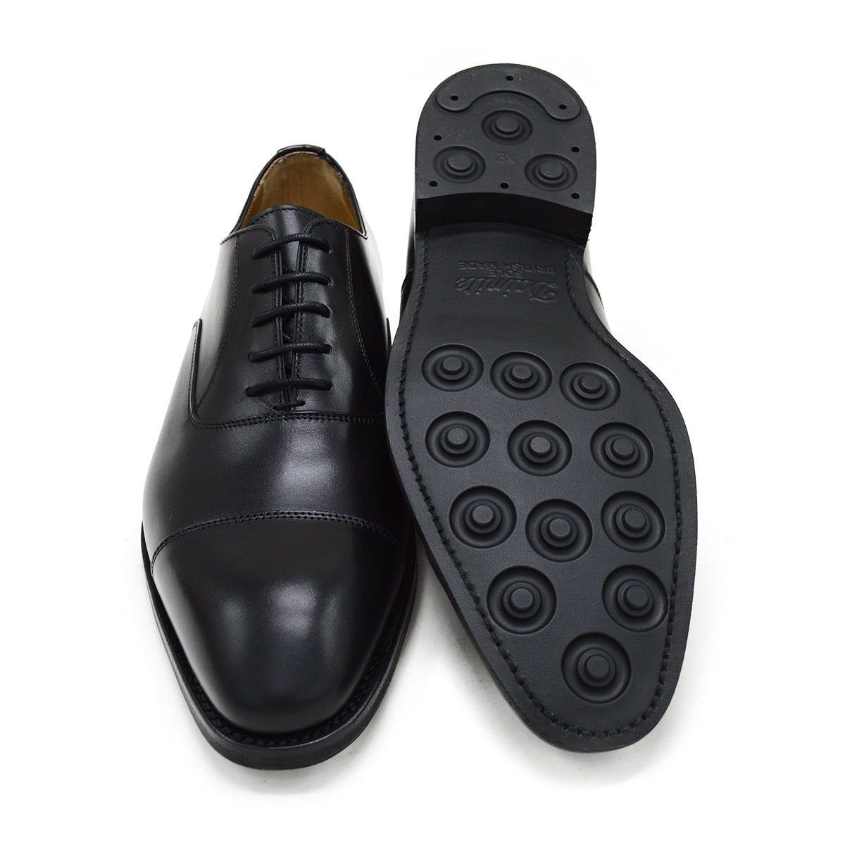 A Berwick 1707 black leather Oxford shoe with a chisel toe and lace-up closure with a Dainite rubber studded sole, on a white background.