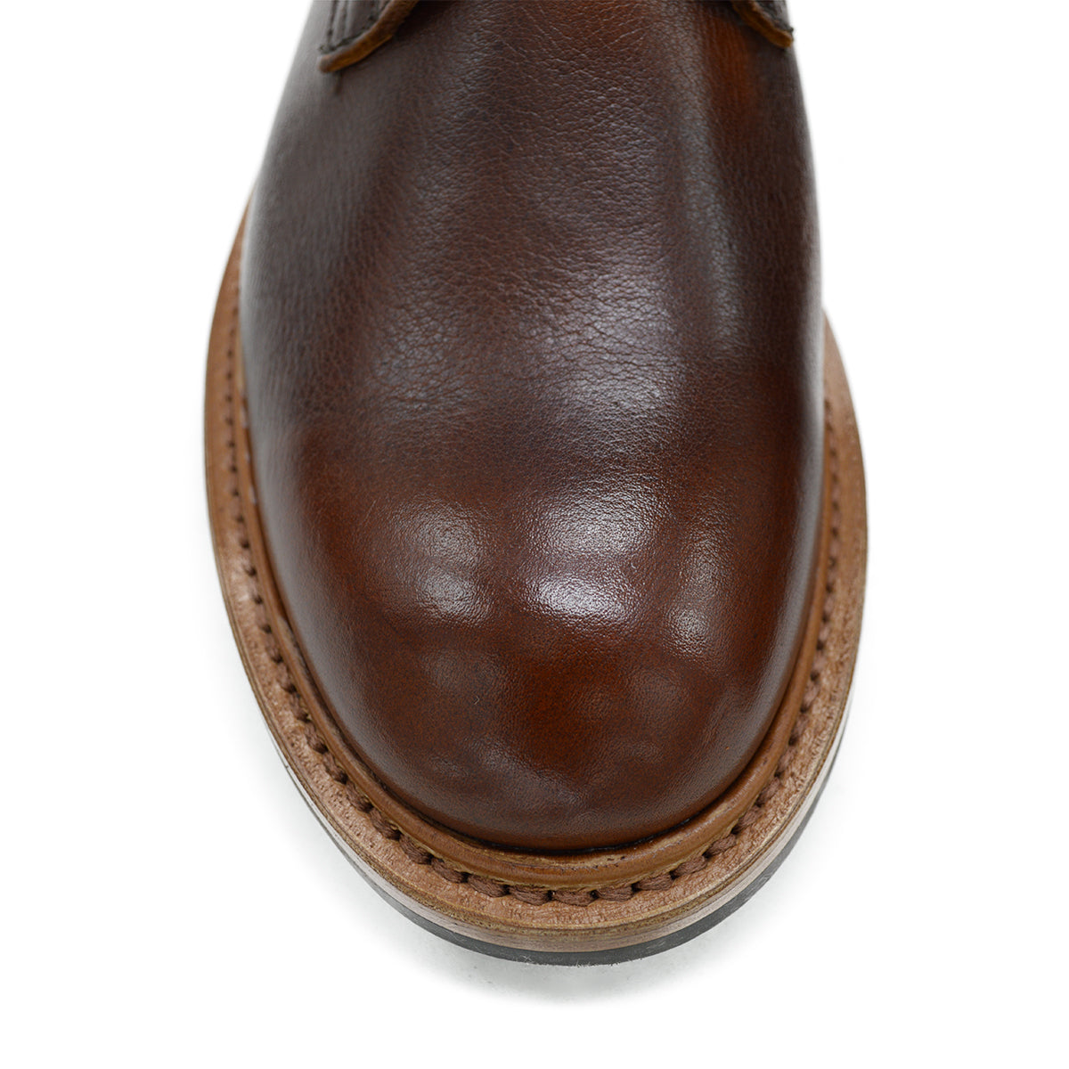 A brown leather service boot with a dainite sole and brass eyelets, designed for the forestry industry.