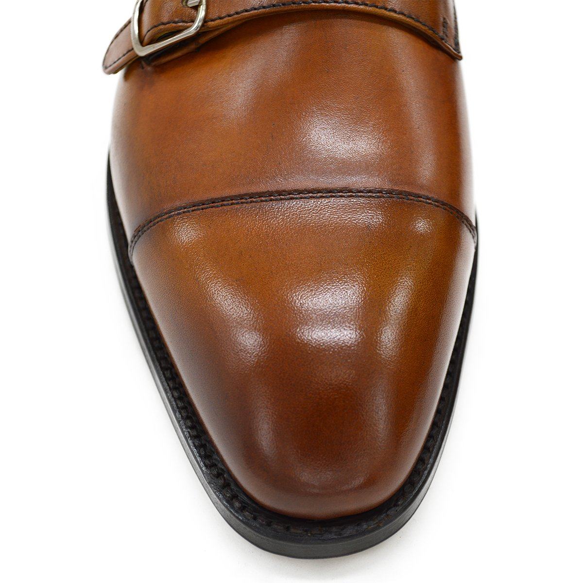 A brown double monk strap shoe with a polished leather upper and a Goodyear welted sole.