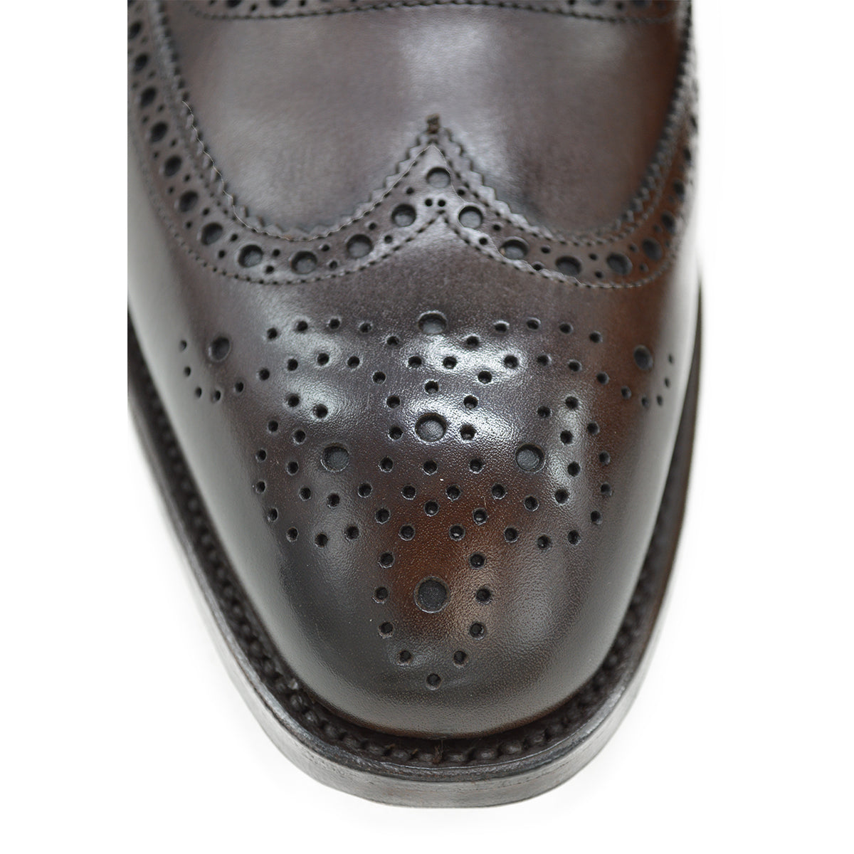 A dark brown Oxford brogue shoe with intricate brogue detailing and a goodyear welted leather sole.