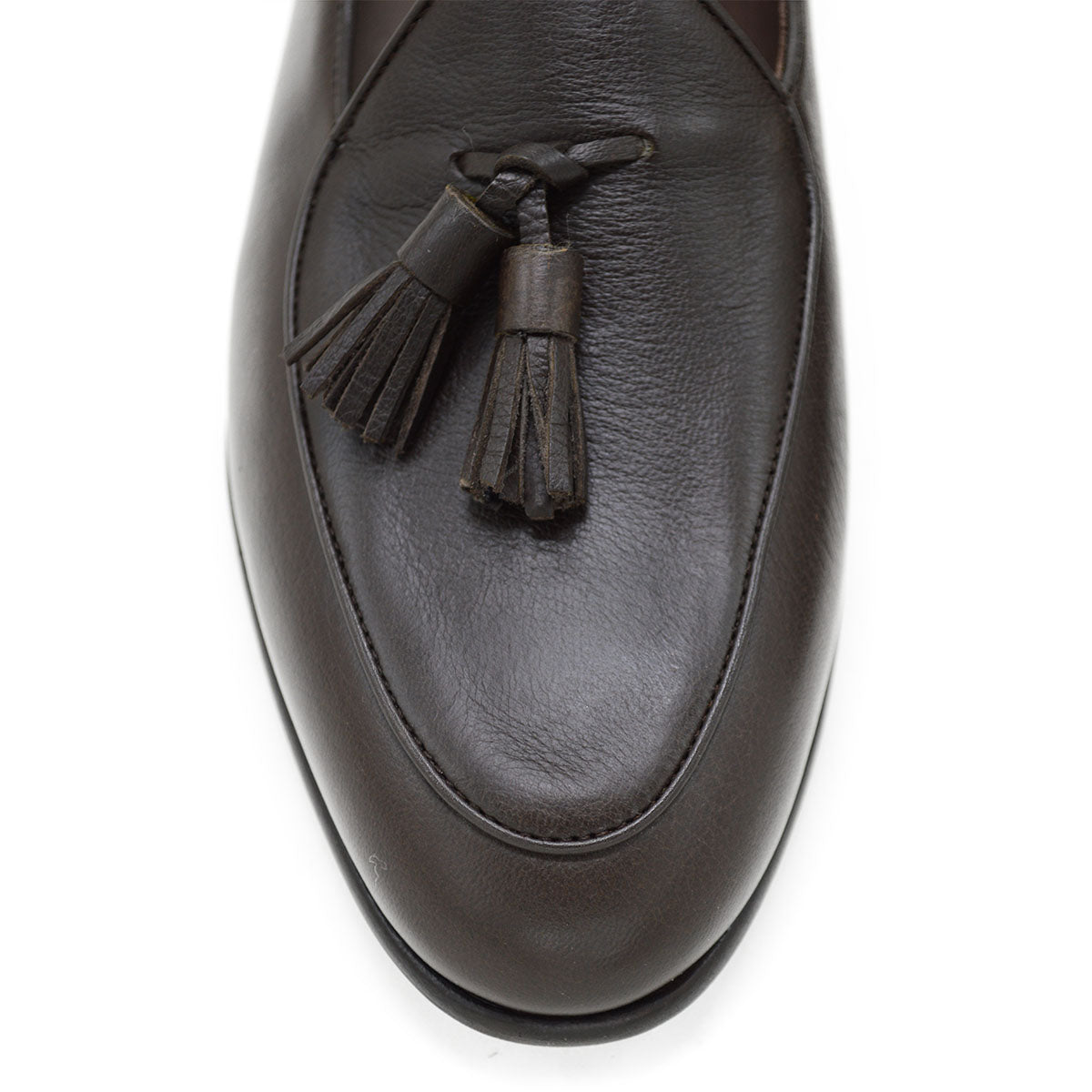A Berwick 1707 dark brown deerskin Belgian loafer with a tassel detail on the vamp, displayed on a white background.