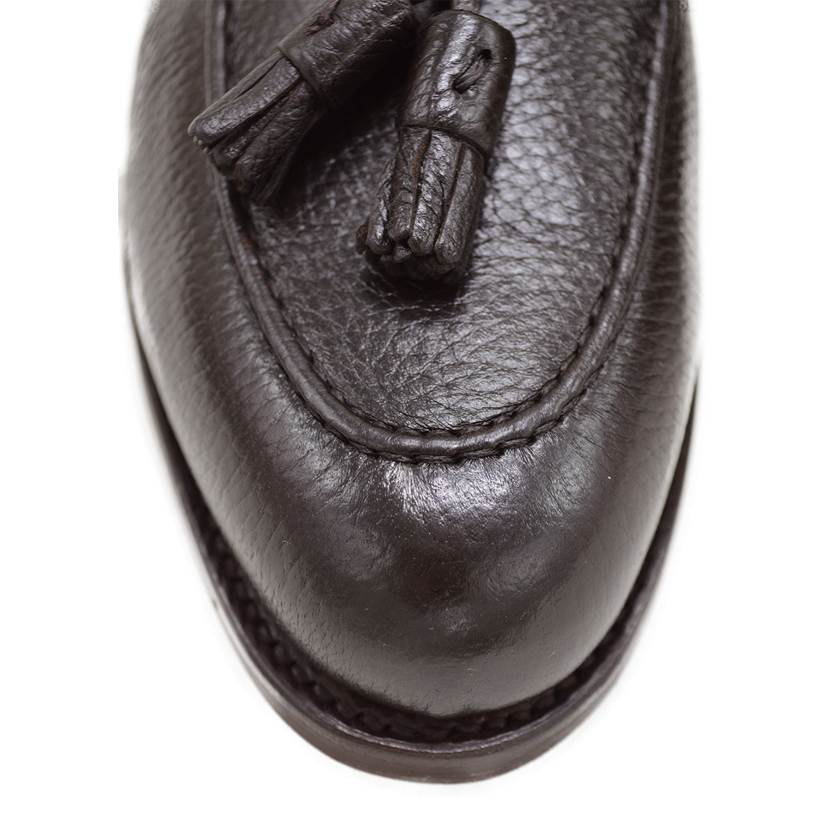 A Berwick 1707 dark brown deerskin slip-on loafer with a tassel detail on the vamp & Dainite sole, displayed on a plain background