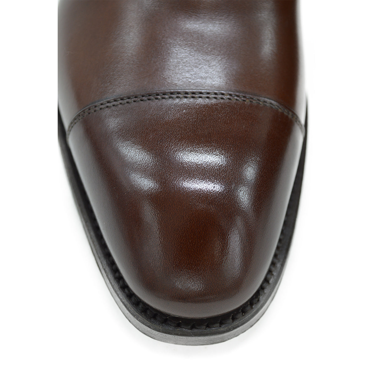 A Berwick 1707 dark brown, chisel toe Oxford shoe with a lace-up closure and a single leather sole.