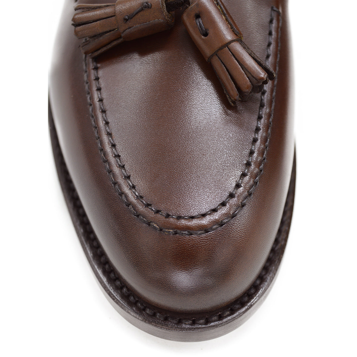 A Berwick 1707 brown tasseled loafer shoe with a closed toe and leather sole.