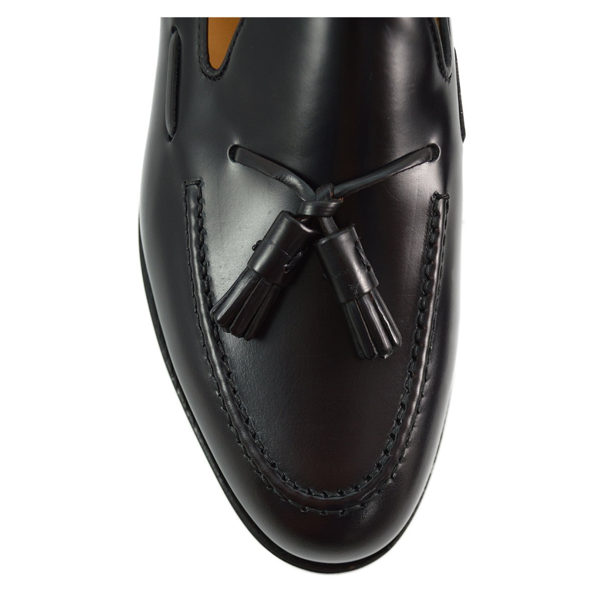 A Berwick 1707 dark brown tasselled slip-on shoe with a polished, smooth upper and a Dainite rubber sole.