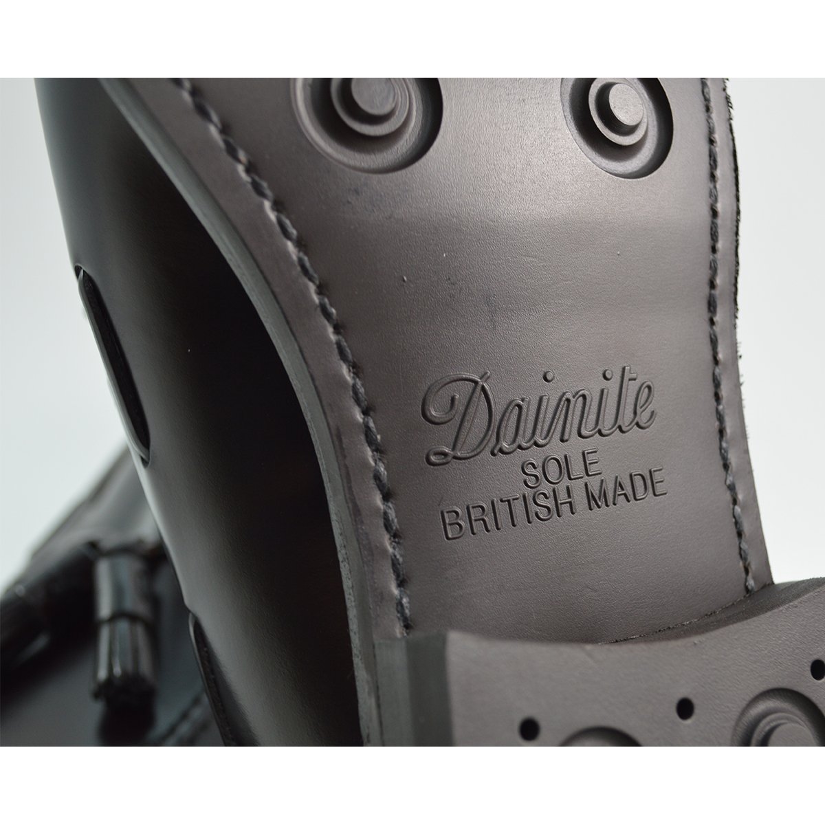 A Berwick 1707 dark brown tasselled slip-on shoe with a polished, smooth upper and a Dainite rubber sole.