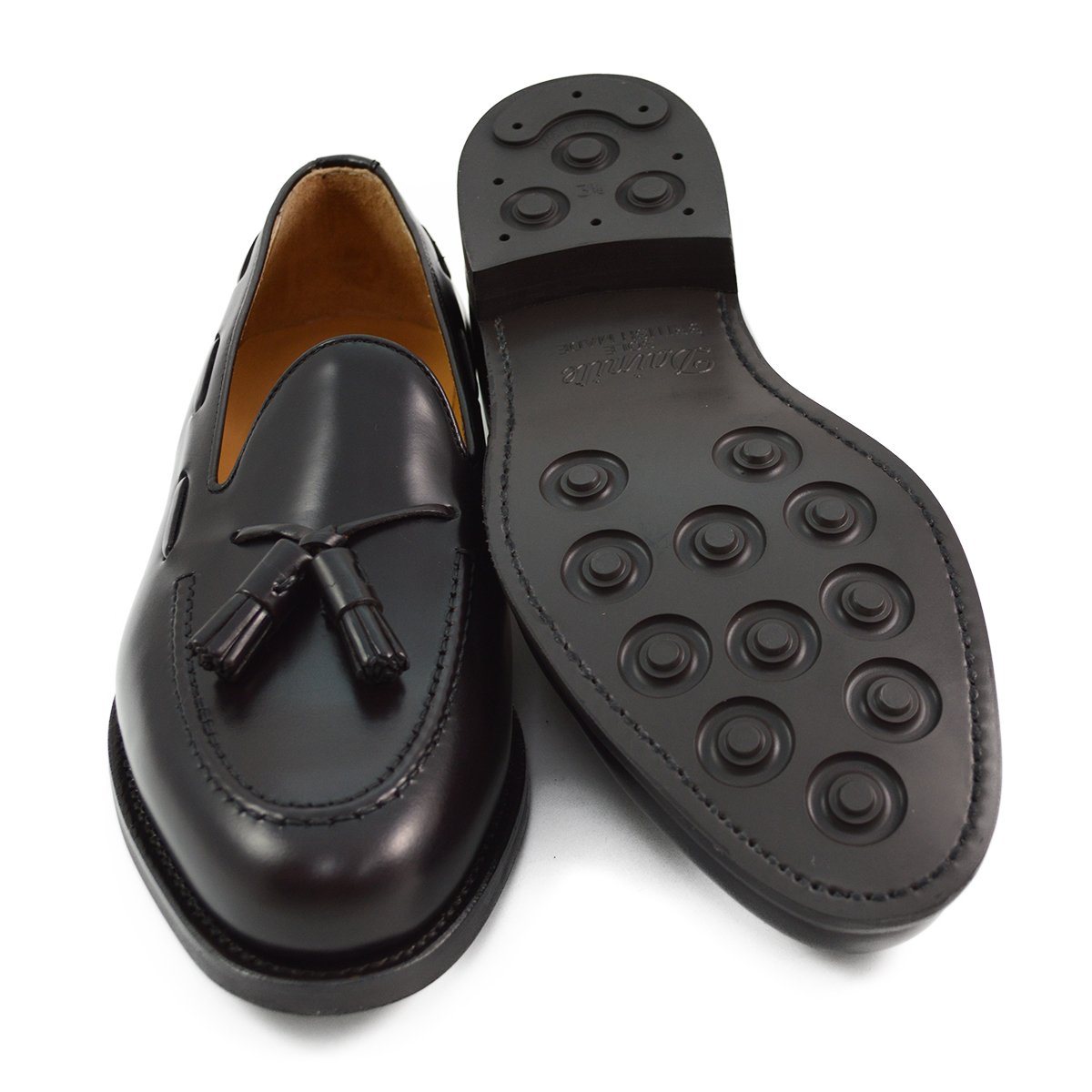 A Berwick 1707 dark brown tasselled slip-on shoe with a polished, smooth upper and a Dainite rubber sole.
