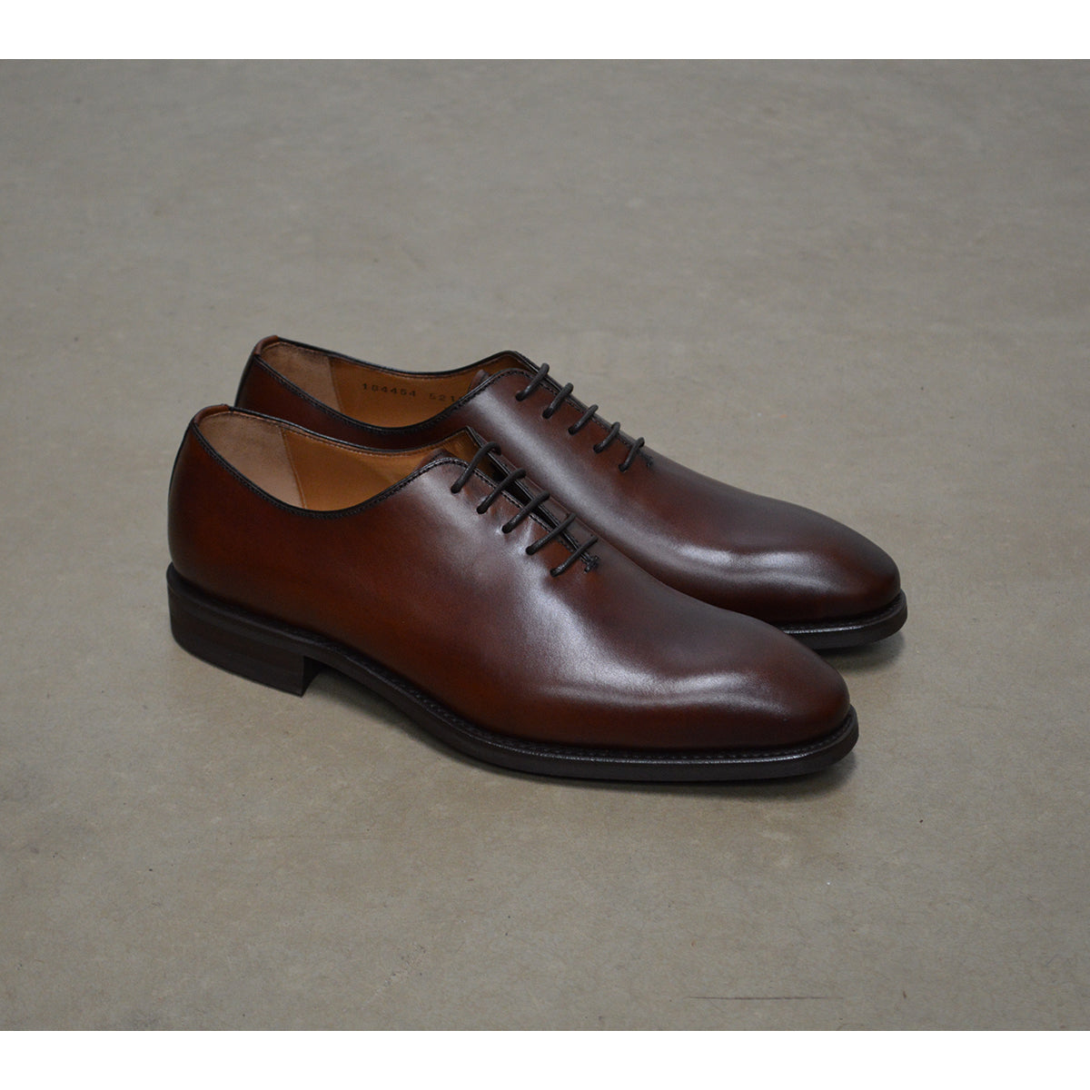 A Berwick 1707 brown leather wholecut oxford shoe with a lace-up closure and a round toe.