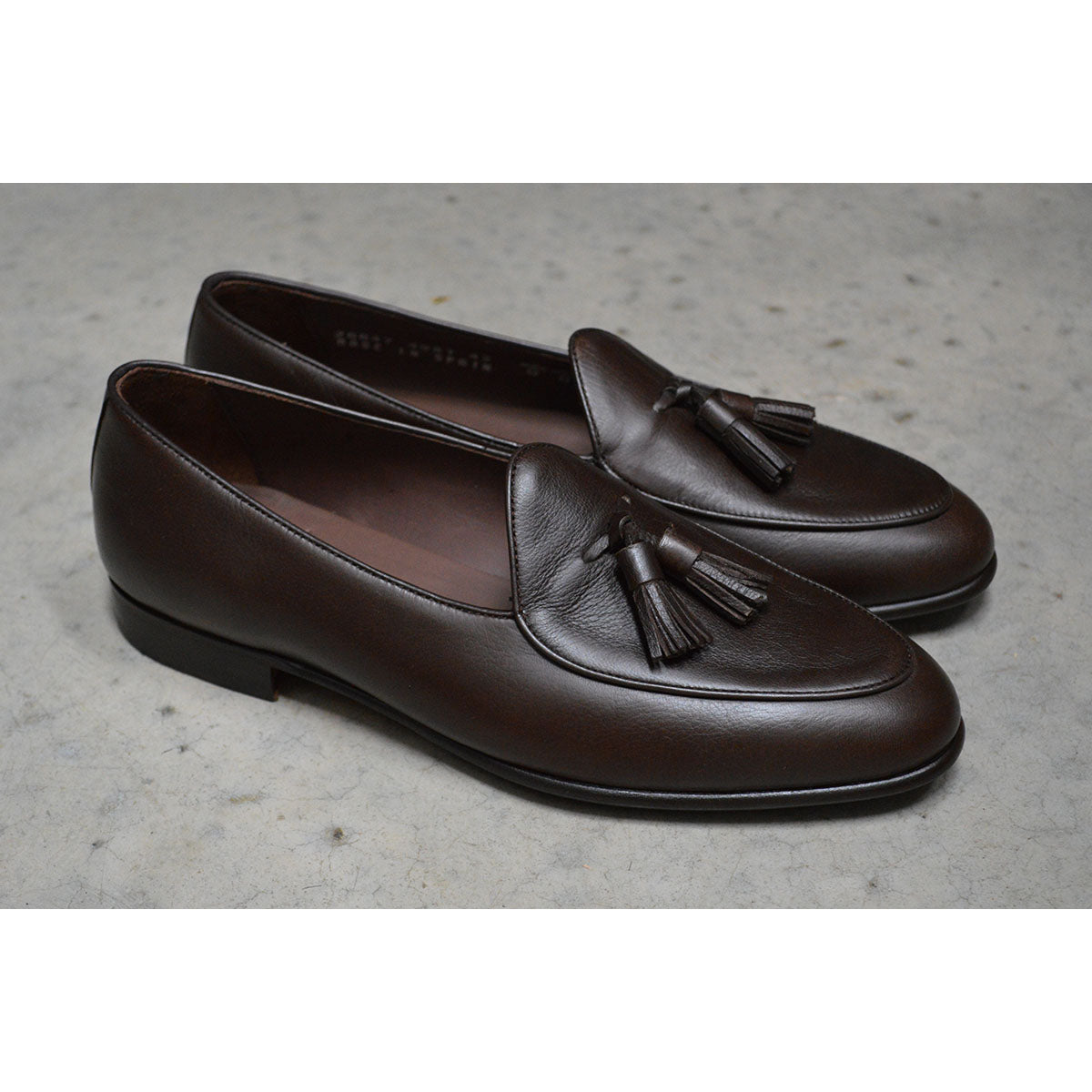 A Berwick 1707 dark brown deerskin Belgian loafer with a tassel detail on the vamp
