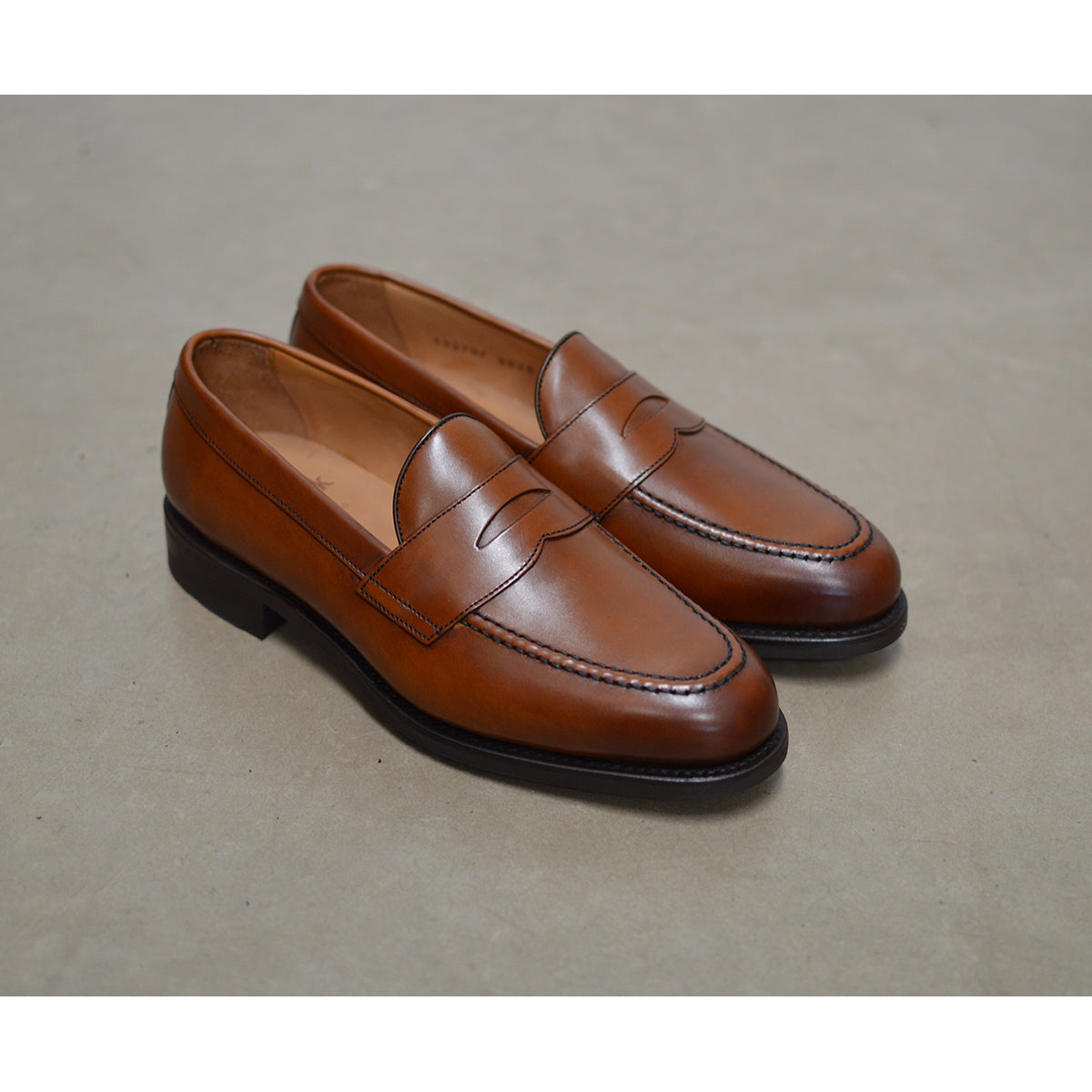 Berwick 1707 Brown tan leather loafer shoe on a polished concrete background with Dainite Soles