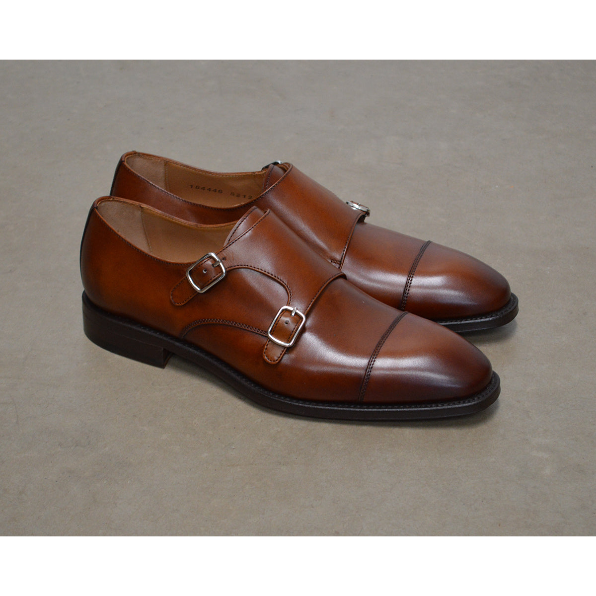 A brown Berwick 1707 double monk shoe with double buckle monk strap on a white background.