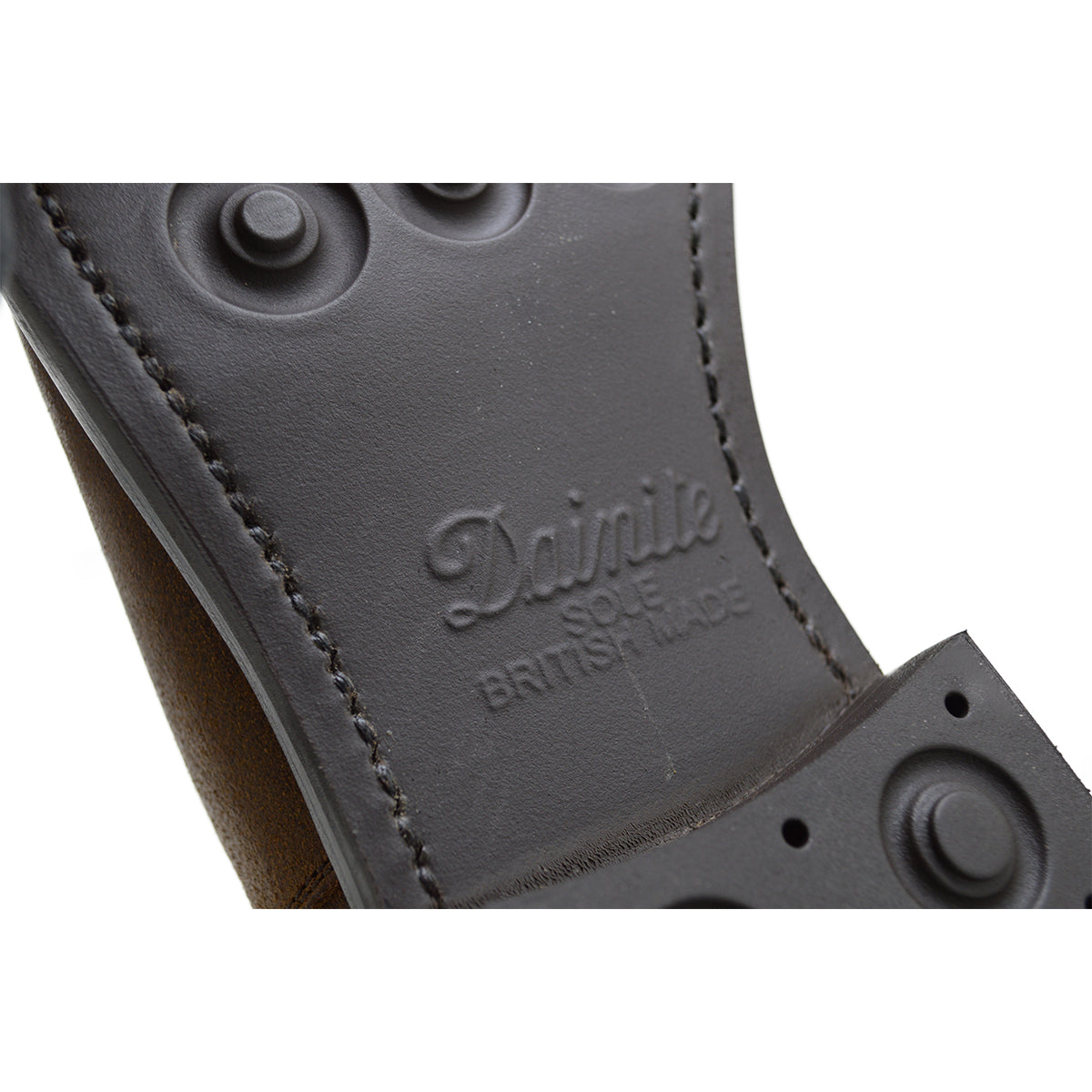 A dark brown Chelsea boot with a waxy leather finish and a contrasting black elastic side panel. The boot has a low heel and a small pull tab at the rear.