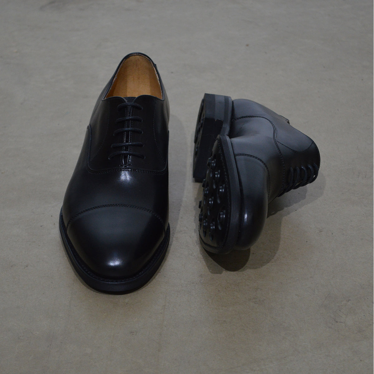 A Berwick 1707 black Oxford shoe with a polished, smooth upper and a Dainite rubber sole.