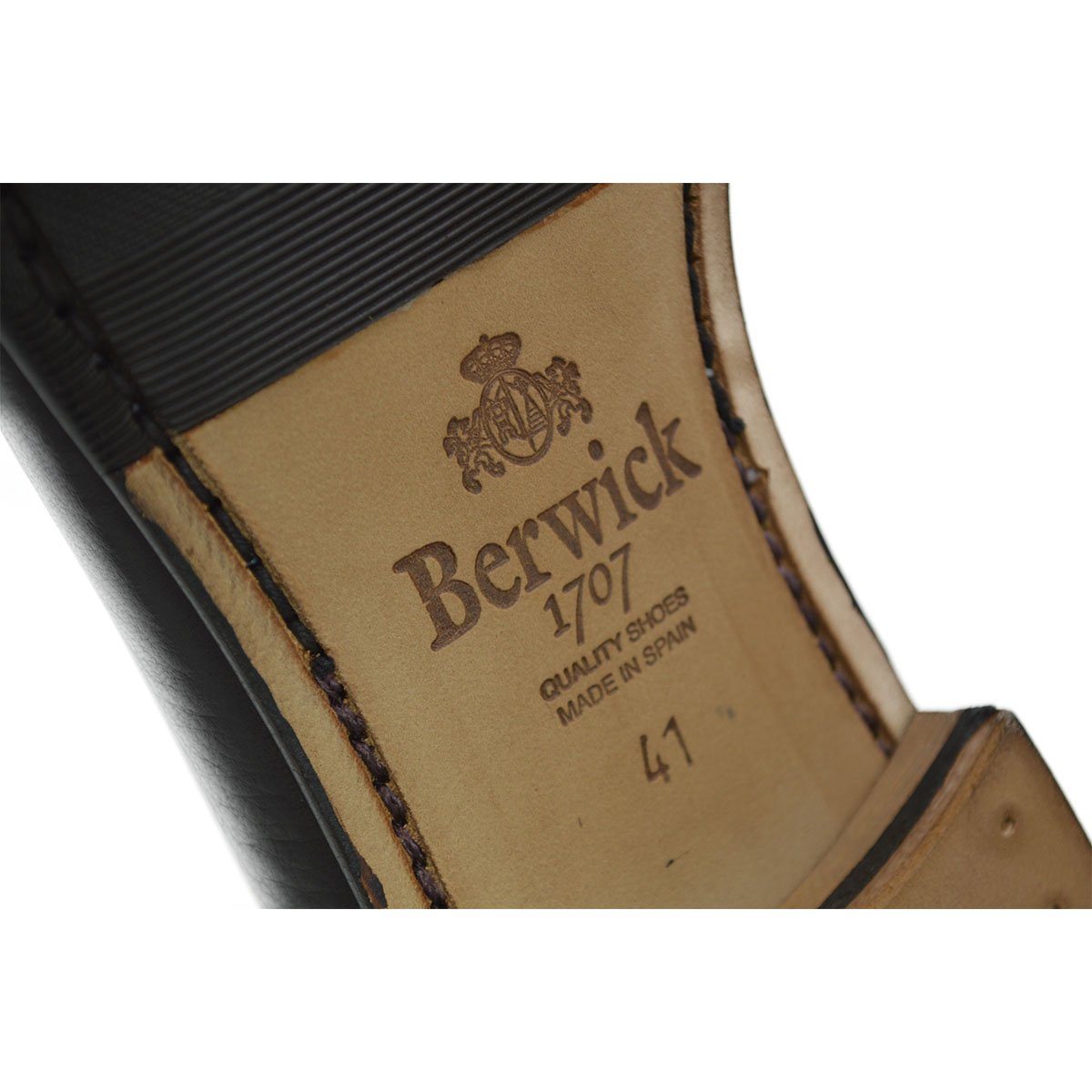 A dark brown deerskin leather Belgian loafer with an almond toe shape and minimal stitching.