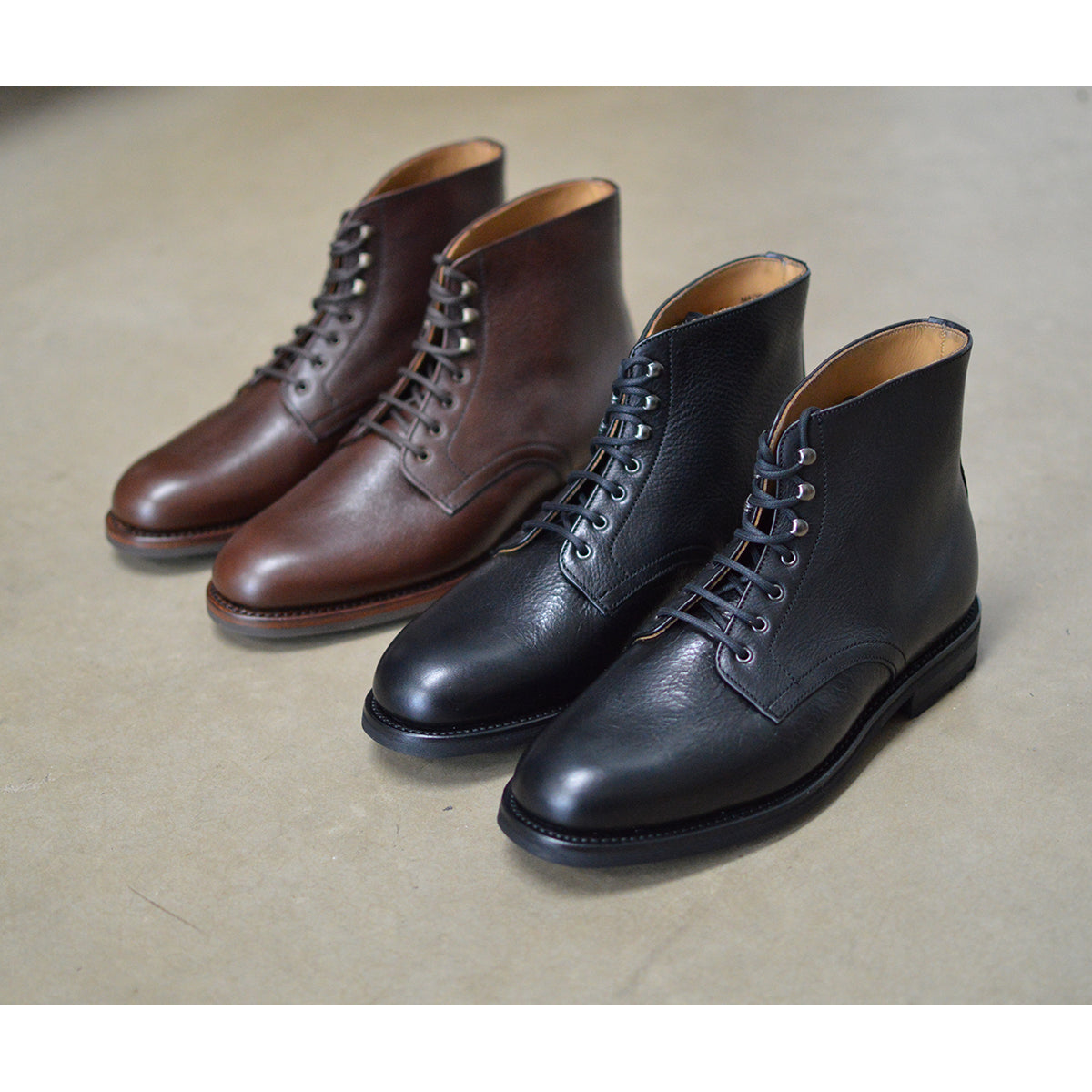 Berwick 1707 Black Kudu leather boot with laces and Vibram rubber sole on a polished concrete background