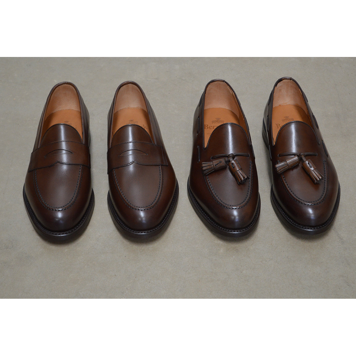 A Berwick 1707 brown tasseled loafer shoe with a closed toe and leather sole.