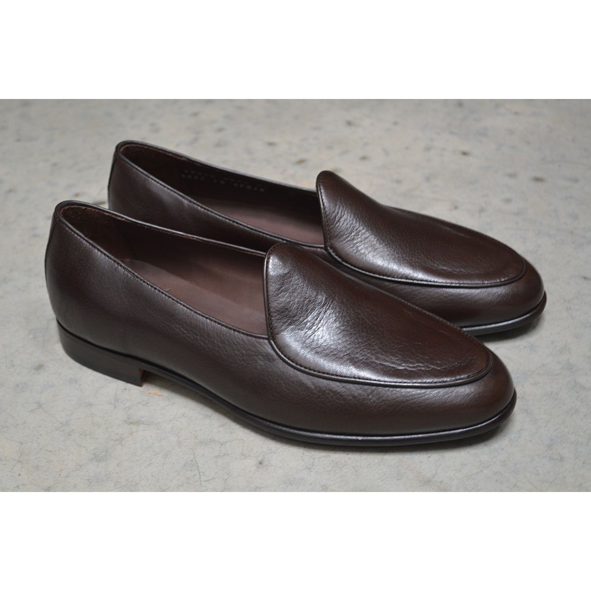 A dark brown deerskin leather Belgian loafer with an almond toe shape and minimal stitching.