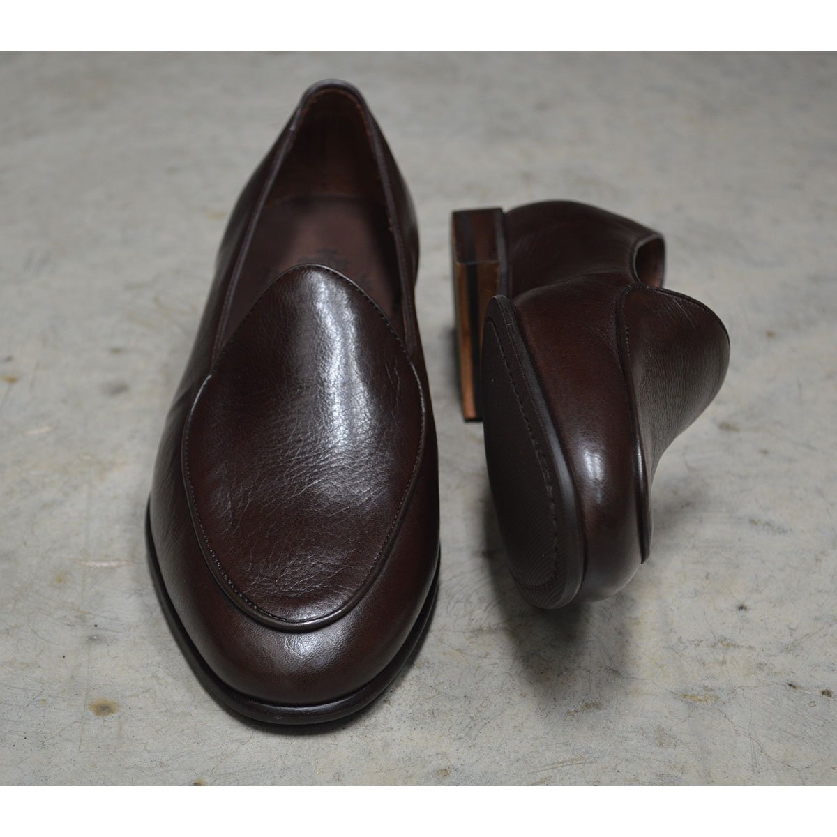 A dark brown deerskin leather Belgian loafer with an almond toe shape and minimal stitching.