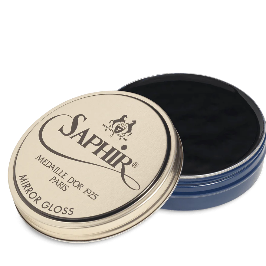 A tin of Saphir Medaille D'Or Mirror Gloss Wax Polish with the brand's logo and product name displayed on the lid.