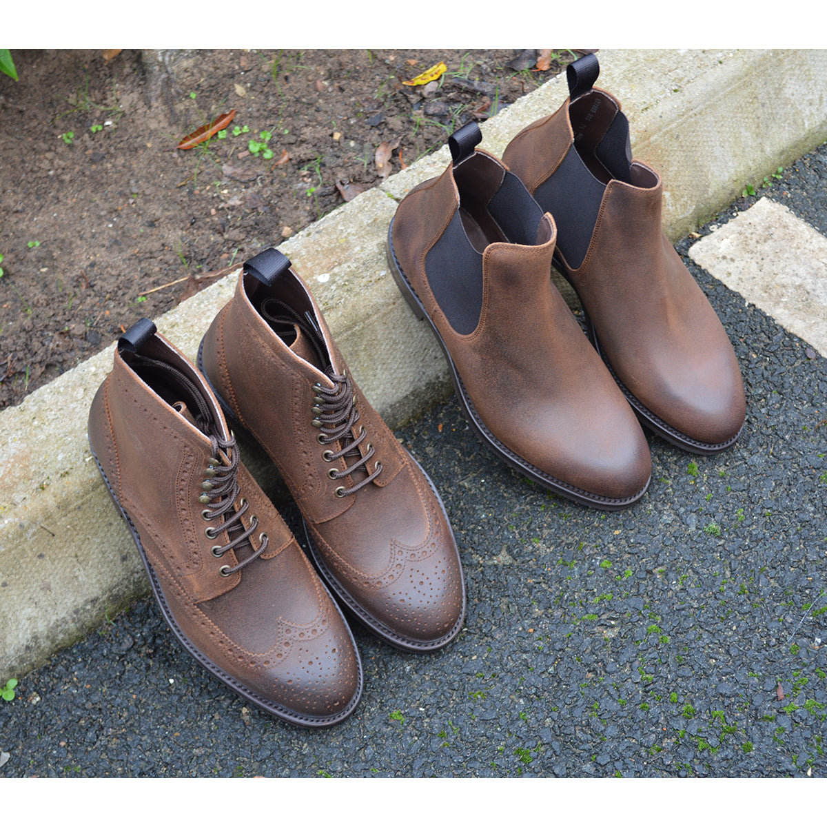 A dark brown lace-up brogue boot with a rubber sole and visible stitching on the upper part.