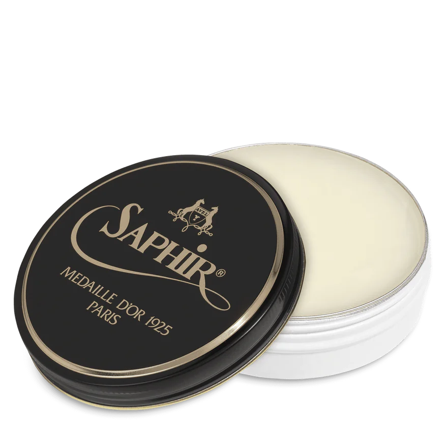 A round tin container of Saphir Medaille D'Or shoe wax polish with black lid and gold lettering.