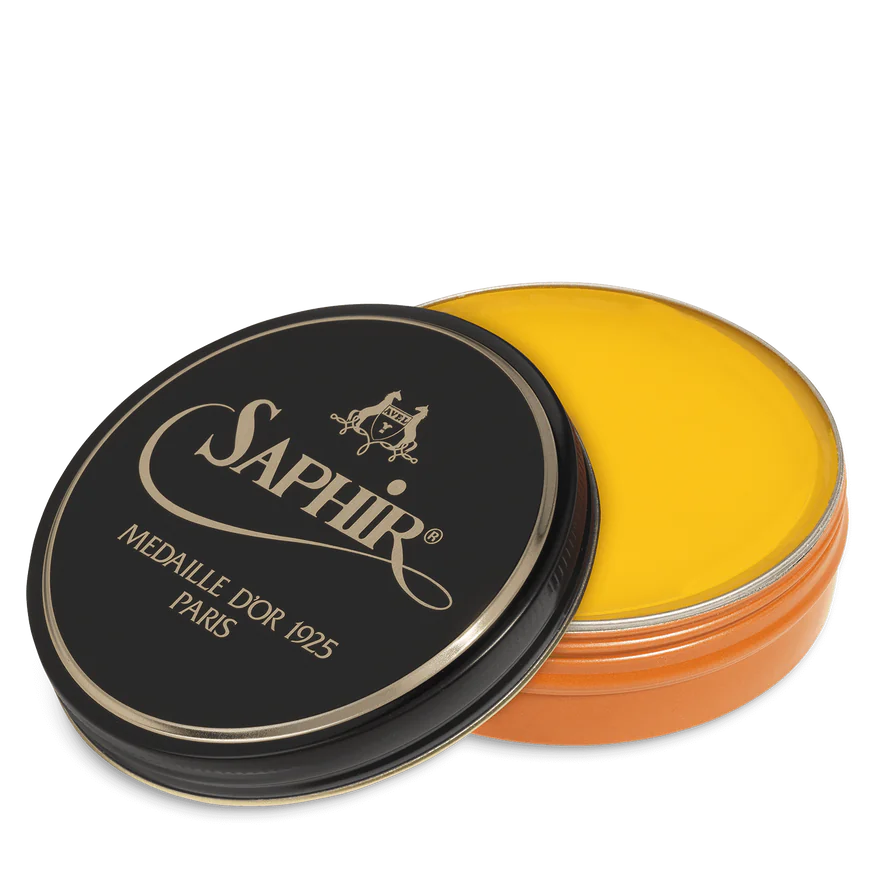 A round tin container of Saphir Medaille D'Or shoe wax polish with black lid and gold lettering.
