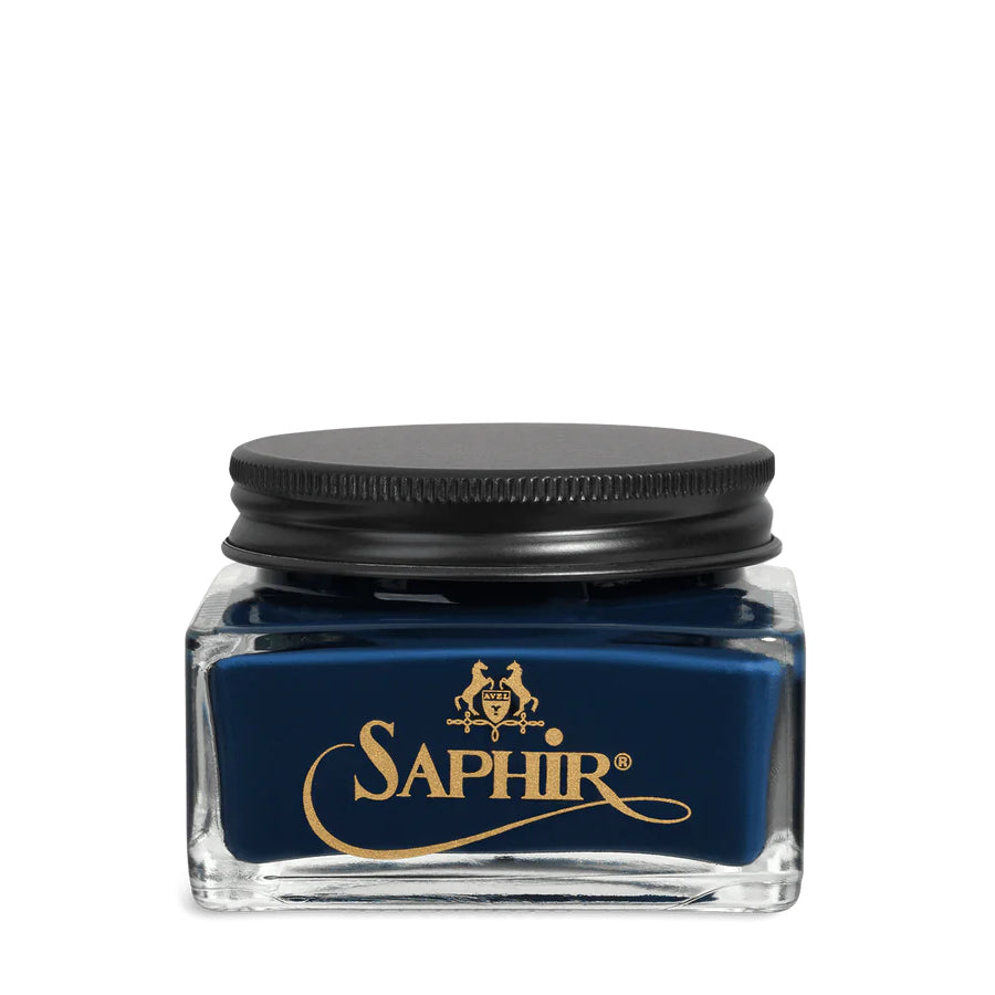 A glass jar with a black lid labeled 'SAPHIR' containing cream shoe polish.